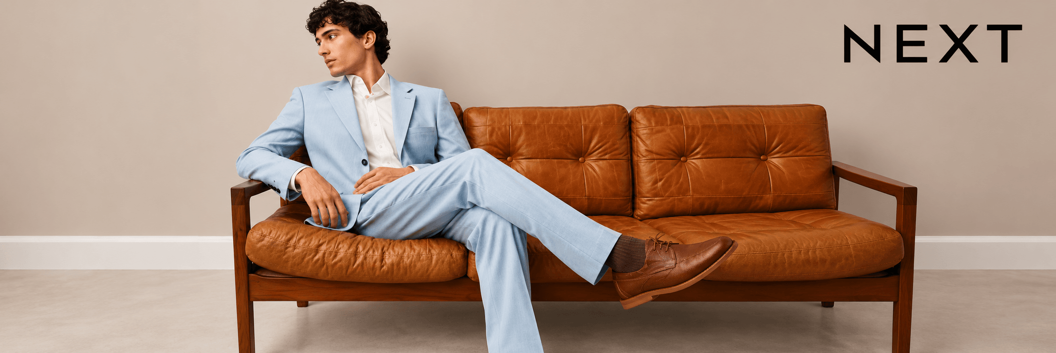 Next menswear campaign featuring a man in a blue suit